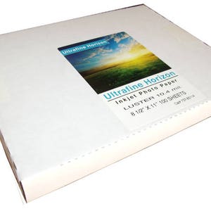 May include: A white rectangular box of Ultrafine Horizon inkjet photo paper. The label shows a landscape image of a field and sky. The box contains 100 sheets of 8 1/2" x 11" Luster 10.4 mil. paper.