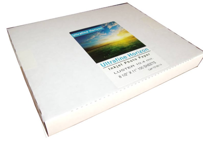 May include: A white rectangular box of Ultrafine Horizon inkjet photo paper. The label shows a landscape image of a field and sky. The box contains 100 sheets of 8 1/2" x 11" Luster 10.4 mil. paper.