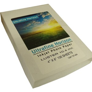 May include: A white box of Ultrafine Horizon inkjet photo paper. The box features a landscape image and text that reads "LUSTER 10.4 mil. 4" X 6" 100 SHEETS."