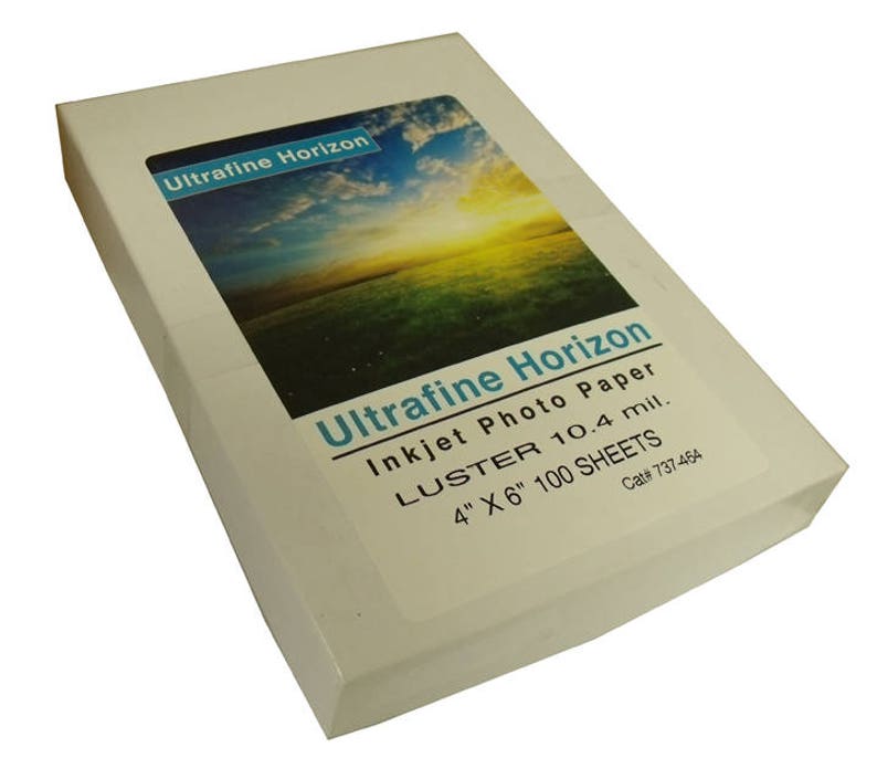 May include: A white box of Ultrafine Horizon inkjet photo paper. The box features a landscape image and text that reads "LUSTER 10.4 mil. 4" X 6" 100 SHEETS."