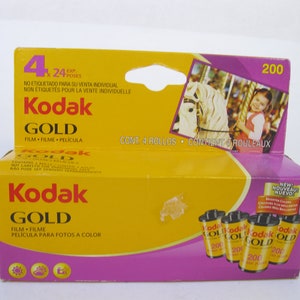 May include: A yellow and purple Kodak Gold film box containing four rolls of 200-speed film. The box features the Kodak Gold logo, film details, and a carousel image. The box also includes text in English, French, and Spanish.