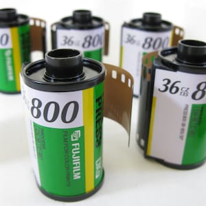 May include: Five rolls of 36 exposure Fujifilm 800 speed film. The film is green and yellow with black text that reads "Fujifilm", "Press 800", "Film for Color Prints", "Process CN-16", and "36 exp 135".