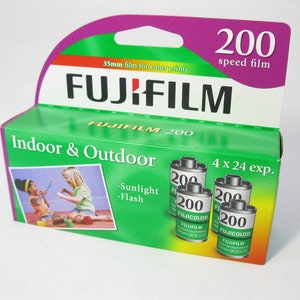 May include: A green and purple box of Fujifilm 200 speed film for color prints. The box shows a photo of two children playing with a toy. The text on the box reads "Indoor & Outdoor", "Sunlight", "Flash", "4 x 24 exp.", and "Fujicolor Fujifilm 200".