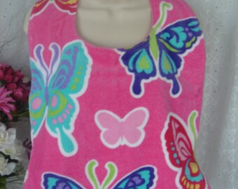 Butterfly bib with a  pink background and cuddle flannel backing.