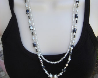 Black and Silver beaded necklace with Silver toned Vine Pendant.  Matching drop earrings.