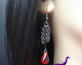 A delicate set of chains adorn this earring set that is made to compliment the silver skull chokers.