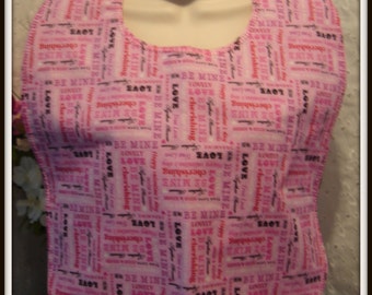 Valentine expressions on a bright pink background adorn this bib for adults/teens