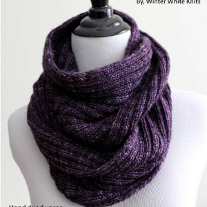 May include: A purple hand-dyed yarn cowl, knitted in a simple stitch pattern. The cowl is displayed on a white mannequin. The text "KNITTING PATTERN" and "By, Winter White Knits" is displayed above the cowl. The text "Hand dyed yarns" and "By, Winter White Knits" is displayed below the cowl. The text "Yarn available at winterwhiteknits.etsy.com" is displayed below the cowl.