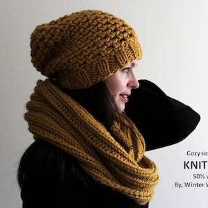 May include: A cozy, mustard yellow knit hat and matching infinity scarf. The hat is slouchy and the scarf is thick and warm. The text "Cozy softness, KNIT HAT 50% wool By, Winter White Knits" is visible in the image.
