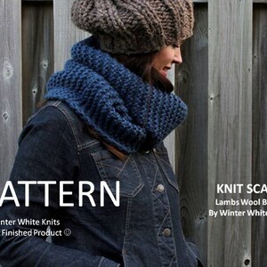 May include: A chunky blue knit scarf and a brown knit beanie. The image includes the text: PATTERN By Winter White Knits Not a Finished Product, and KNIT SCARF Lambs Wool Blend By Winter White Knits. The items are worn over a dark denim jacket.
