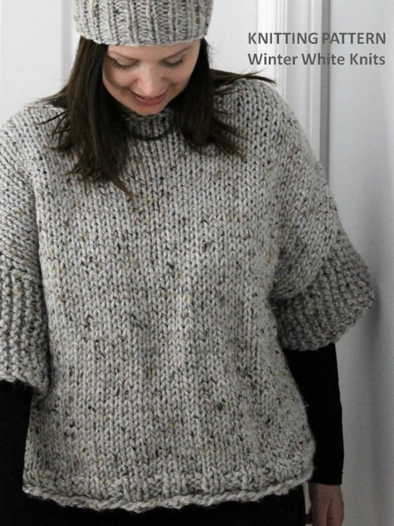 May include: A gray knitted sweater with a speckled pattern. The sweater has a round neckline and long sleeves. The text "KNITTING PATTERN Winter White Knits" is visible in the top right corner of the image.