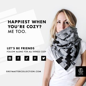 May include: A woman wearing a white t-shirt and a gray and black infinity scarf. The scarf is made of a soft, stretchy fabric and has a unique woven design. The text "Happiest when you're cozy? Me too." is displayed above the woman's head. The text "Let's be friends. Follow along for all things cozy." is displayed below the woman's head. Social media icons for Instagram, Facebook, TikTok, Pinterest, and Twitter are displayed below the text. The text "GREYMATTERCOLLECTION.COM" is displayed below the social media icons. The text "GREY MATTER" is displayed below the woman's right shoulder.