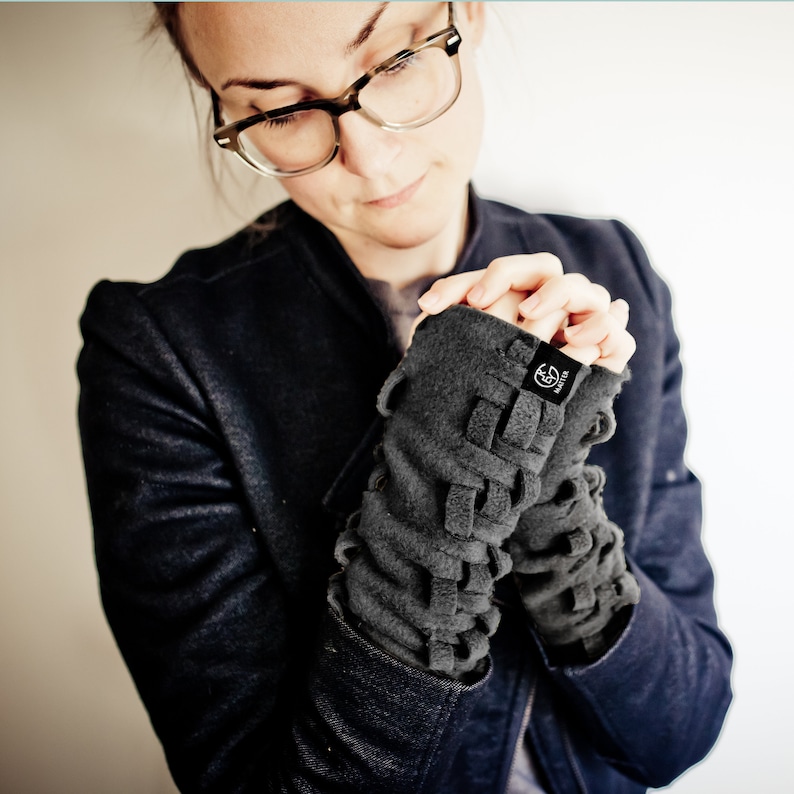 May include: Gray fleece fingerless gloves with a braided design and a small black logo that says "Matter".