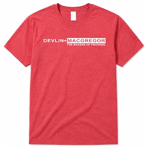 May include: A heathered red short-sleeve t-shirt featuring white text on the chest that reads DEVLIN+MACGREGOR THE MAKERS OF PROVASIC. The shirt has a crew neckline and a standard fit, showcasing a textured fabric appearance throughout the garment.