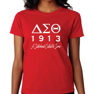 May include: Red t-shirt with white text that reads "ΔΣΘ 1913 A Sisterhood Called to Serve"