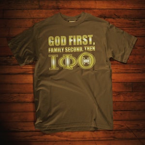 May include: A green t-shirt with the text "God First, Family Second, Then IΦΦ" in gold lettering.
