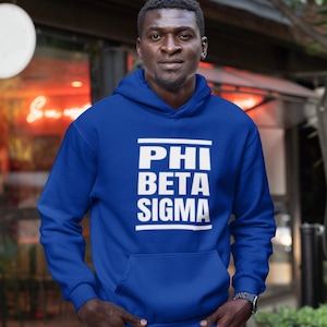 May include: A royal blue hooded sweatshirt with the text "PHI BETA SIGMA" printed in white.