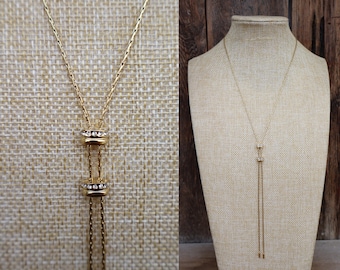 Jaren 90 goudkleurige dubbele schuif bolo strass bolo lariat kwastketting