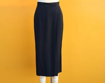 May include: A black maxi skirt with a high waist and a straight silhouette.