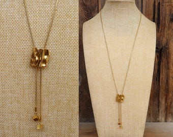 Jaren 90 goudkleurige schuifknop bolo modernistische gekreukte geo-slangketting lariatketting