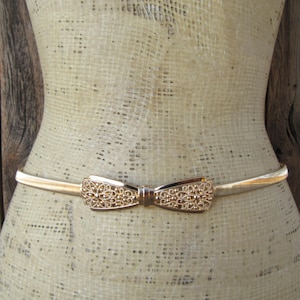1990s Gold Metal Bow Tie Stretch Belt | 80s 90s Filigree Bow Buckle Gold Metal Skinny Slinky Belt | 27 to 36
