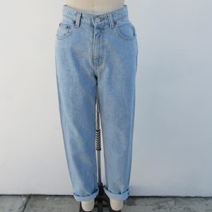 May include: Light blue denim jeans with a high waist and a relaxed fit. The jeans have a cuffed hem and are made of a soft, comfortable fabric.