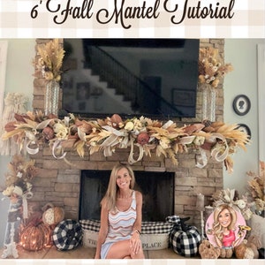 May include: A fireplace mantel decorated with a fall-themed garland featuring dried grasses, flowers, and ribbon. The garland is draped across the mantel and hangs down on either side. There are two tall vases with dried flowers on either side of the fireplace. The fireplace is made of stone and has a black screen in front of it. A woman is sitting in front of the fireplace. There are pumpkins and other fall decorations on the hearth.