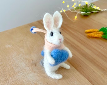 Needle Felted bunny holding blue wool heart