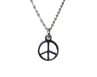 May include: A silver chain necklace with a peace sign pendant.