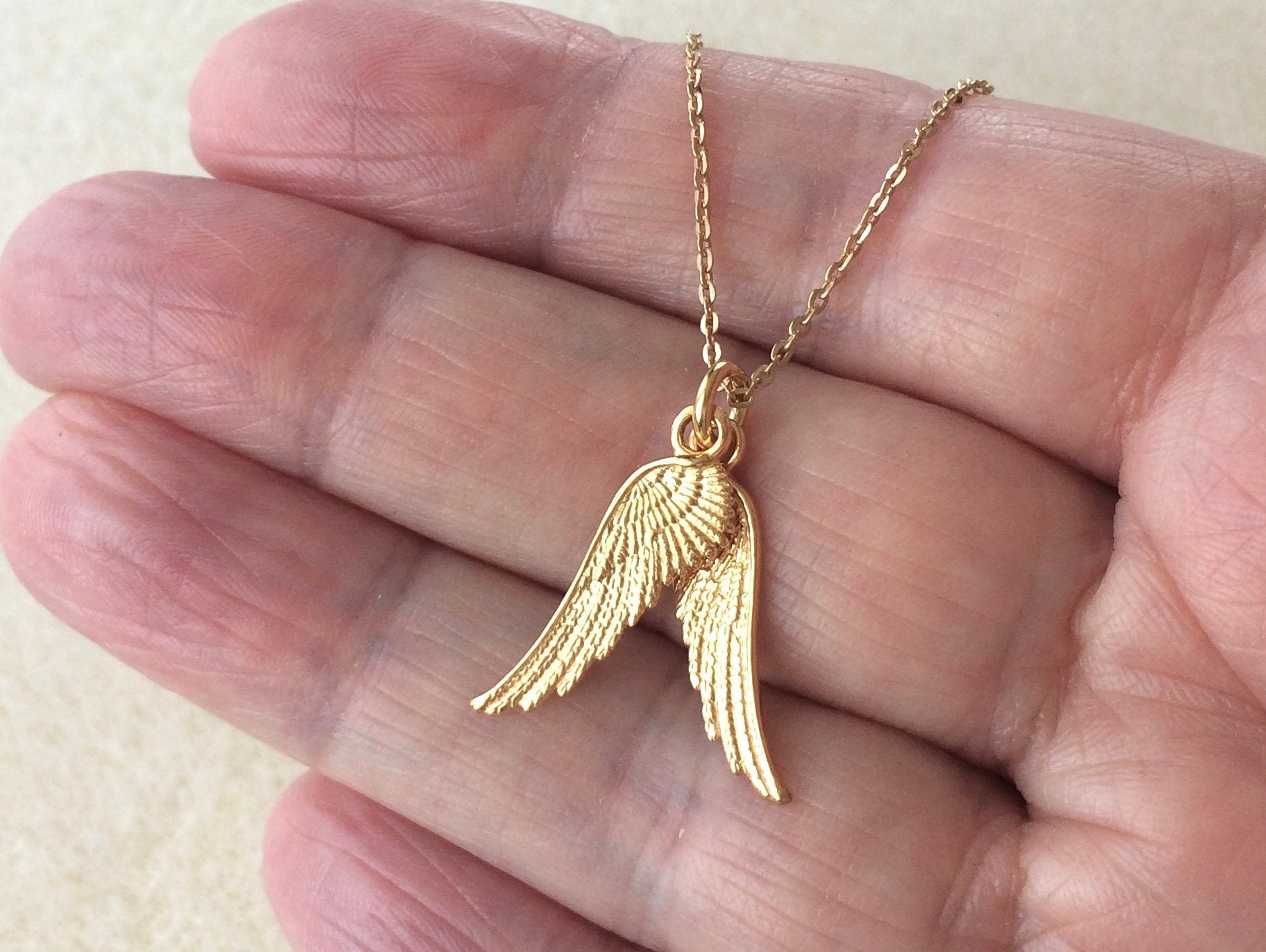 Louis Vuitton Gold Tone Collier Logo Angel Pendant Necklace at 1stDibs  lv  airplane necklace, lv pendant gold, louis vuitton airplane necklace