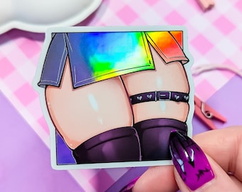May include: A sticker of a cartoon character wearing a rainbow skirt and black thigh-highs with a black belt with silver heart-shaped buckles.