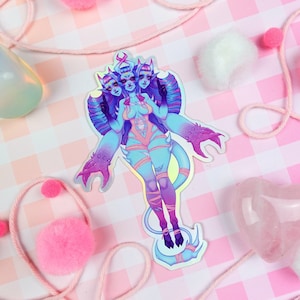 May include: A holographic sticker featuring a blue and purple three-headed demon with a pink and yellow outfit. The demon has three pairs of arms and is standing on a crescent moon.