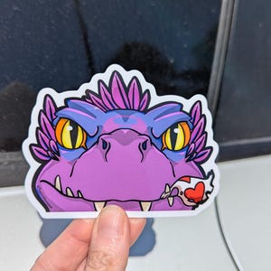 May include: A set of three ceramic mugs with a speckled, matte finish. The mugs are in shades of cream, light gray, and dark gray. Each mug has a simple, minimalist design and a rounded handle.