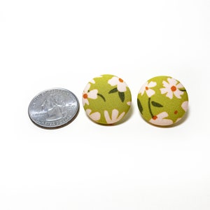 Handmade green floral fabric covered post earrings. The earrings are 0.875 inches, roughly the same size as a quarter.