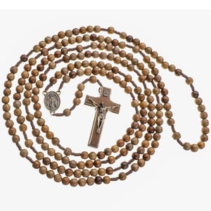 May include: A brown wooden rosary with a brown wooden crucifix and a metal medal of the Virgin Mary. The rosary beads are strung on a brown cord.