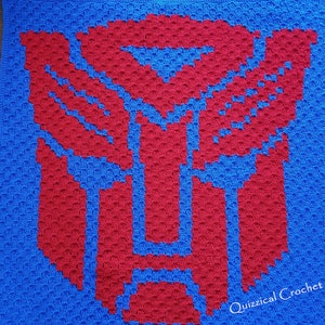 May include: A blue crochet blanket with a red crochet Transformers logo in the center. The blanket is made with a textured stitch and has a white border. The text "Quizzical Crochet" is in the bottom right corner.