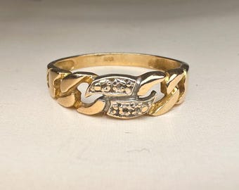 May include: A gold ring with a chain-link design and small white stones.