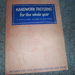 May include: A vintage craft book cover with the title "HANDWORK PATTERNS for the whole year" in white text on a blue rectangle. The cover features line drawings of a church, rabbit, and other shapes. The text "PATTERNS FOR TOYS, PICTURES, POSTERS AND GIFTS" is at the bottom.