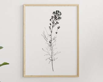 May include: A botanical print in a light wood frame hangs above a round rattan coffee table. A hanging wicker chair with cushions and a blanket is next to a large potted plant. The room has a neutral color palette.