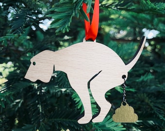 Adorno navideño de perritos haciendo caca