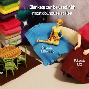 May include: A collection of fleece blankets in various colors and sizes, including a blue blanket with a doll sitting on it, a maroon blanket with a doll sitting on it, and a brown rug with a table and four chairs. The text "Blankets can be used with most dollhouse scales." is written at the top of the image. The text "Half scale 1:24" is written below the table and chairs. The text "3/4 scale 1:18 or 1:16" is written below the blue blanket. The text "Full scale 1:12" is written below the maroon blanket.