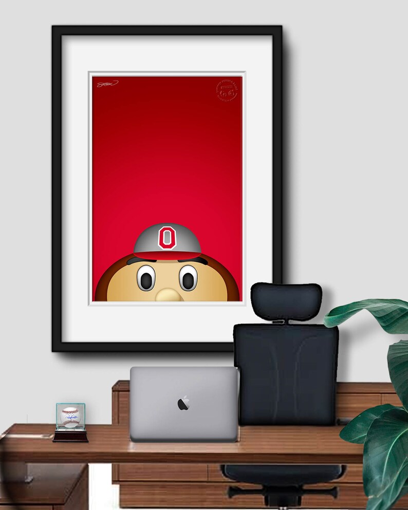 May include: A framed illustration of a cartoon mascot with a red background. The mascot is wearing a grey and red baseball cap with a white "O" on it. The mascot has brown hair, a brown nose, and large brown eyes.