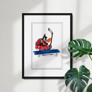 May include: A framed cartoon illustration of a duck wearing a red and white hockey jersey with a black stick in its hand. The duck is looking to the left and has a surprised expression. The text "PENALTY BOX" is written below the duck. The illustration is signed "Speno" in the bottom right corner.