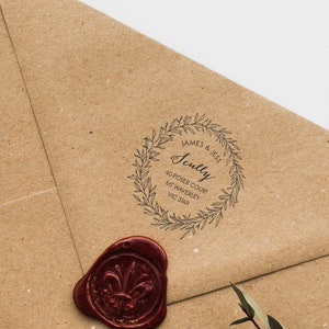 May include: A brown paper envelope with a wax seal and a custom return address stamp. The stamp features a wreath design with the text "James & Jess Sully 45 Fox Court Mt. Vancouver,  WA 98682".