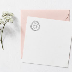 May include: A white envelope with a pink envelope on top. The white envelope has a black and white wreath stamp with the text "James & Jess Scully 40 River Court, Mt Waverley VIC 3149".
