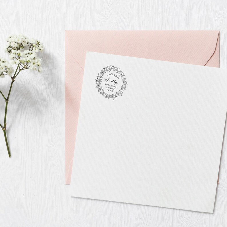 May include: A white envelope with a pink envelope on top. The white envelope has a black and white wreath stamp with the text "James & Jess Scully 40 River Court, Mt Waverley VIC 3149".
