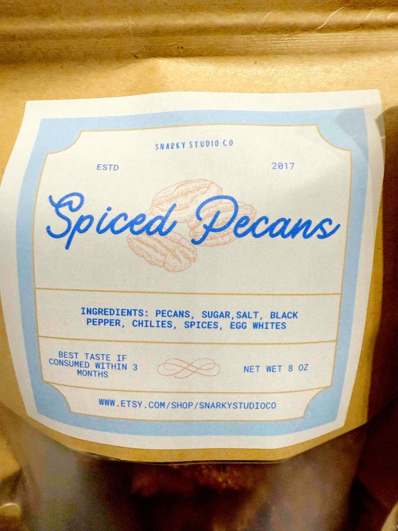 May include: A bag of spiced pecans with a label that reads "Spiced Pecans." The label lists ingredients and the net weight of 8 oz. The Etsy shop URL is also included.