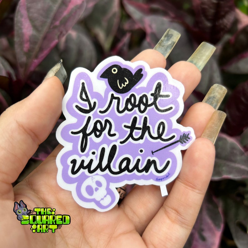 May include: Purple sticker with a black bird, arrow, and skull. The sticker says "I root for the villain".