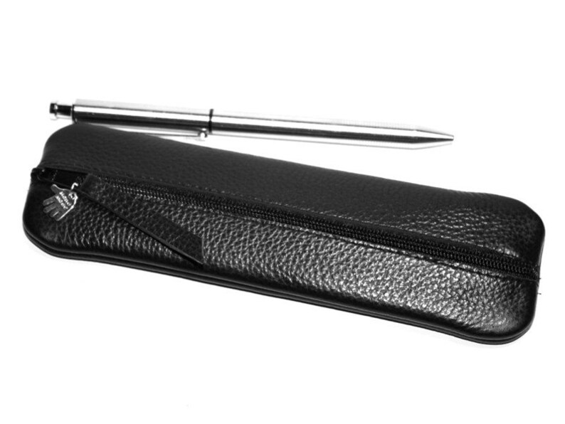 May include: A black leather pencil case with a zipper closure and a silver pen inside.