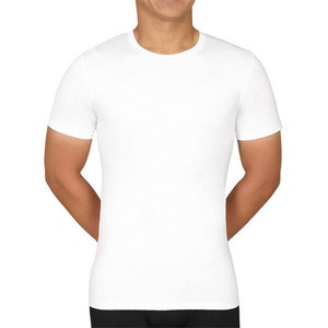 May include: A white, crew neck t-shirt with short sleeves. The shirt is made of a smooth, opaque fabric and has a fitted silhouette. The model is wearing black pants.